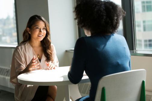 two-women-sitting-on-chair.jpg two women sitting on chair
